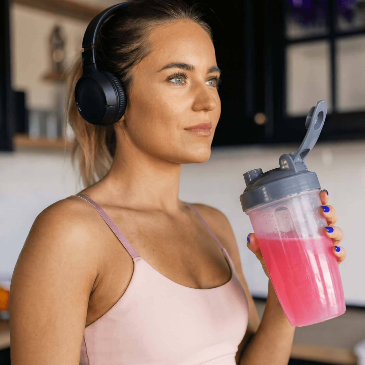 Girl holding shaker drinking Athena Creatine + electrolytes Berry