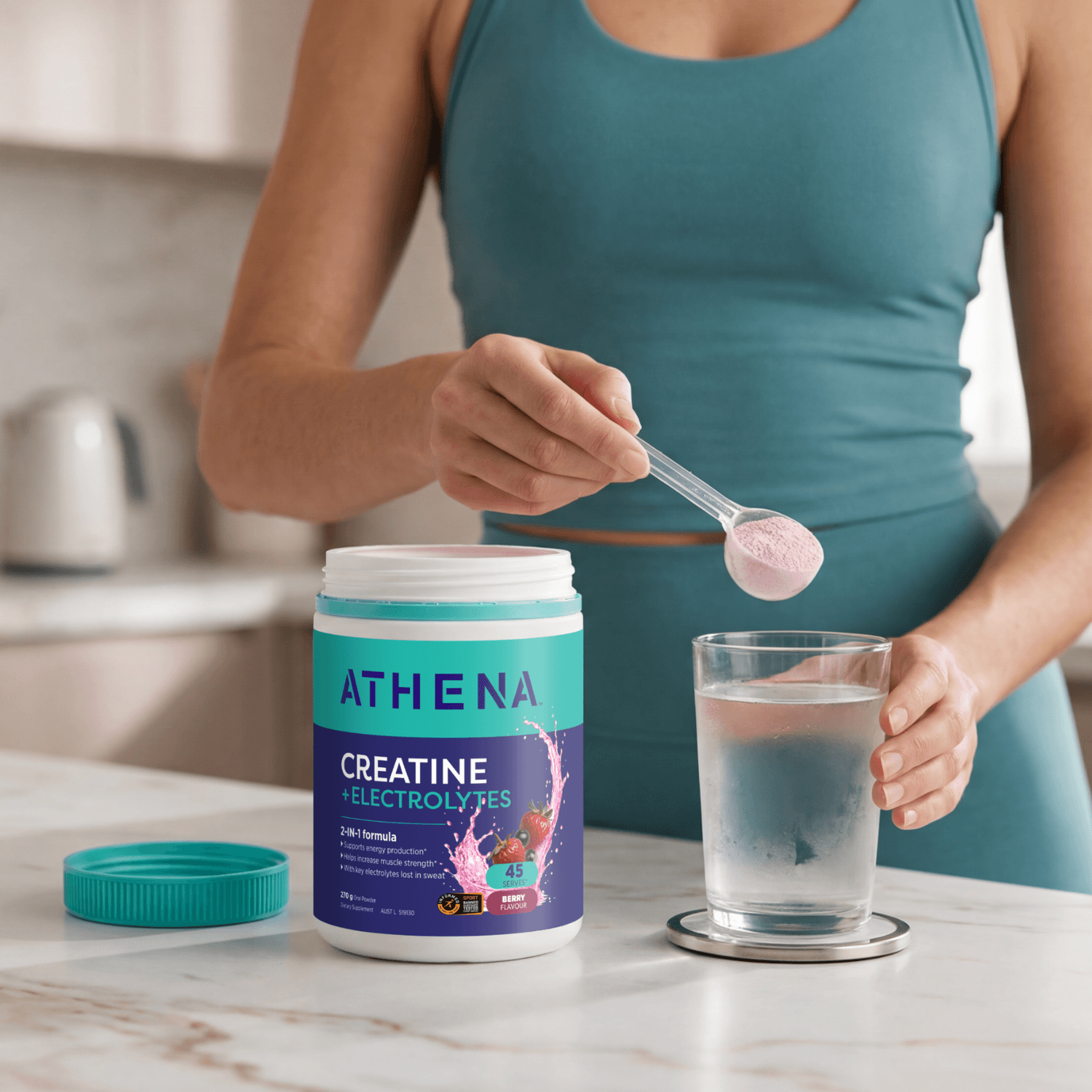 Athena Creatine + electrolytes Berry with women holding scoop over cold water